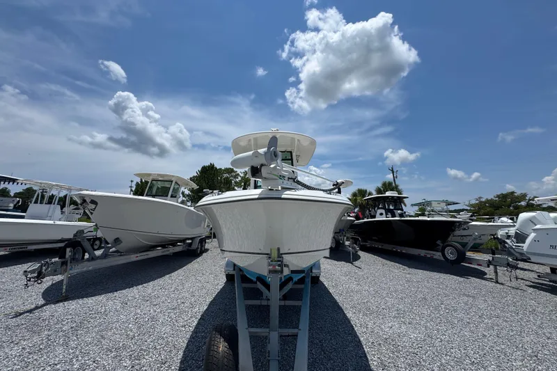 Slide: The Image of 2014 Boston Whaler 250 Outrage boat on trailer under a clear blue sky. - 6