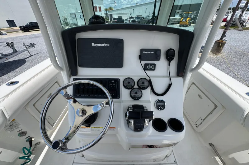 Slide: The Image of 2014 Boston Whaler 250 Outrage helm with Raymarine electronics and steering wheel. - 27