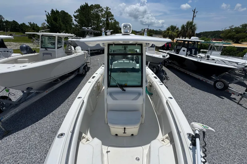 Slide: The Image of 2014 Boston Whaler 250 Outrage boat displayed in a marina setting. - 21