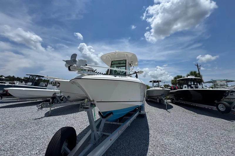 Slide: The Image of 2014 Boston Whaler 250 Outrage boat on trailer under a clear blue sky. - 5