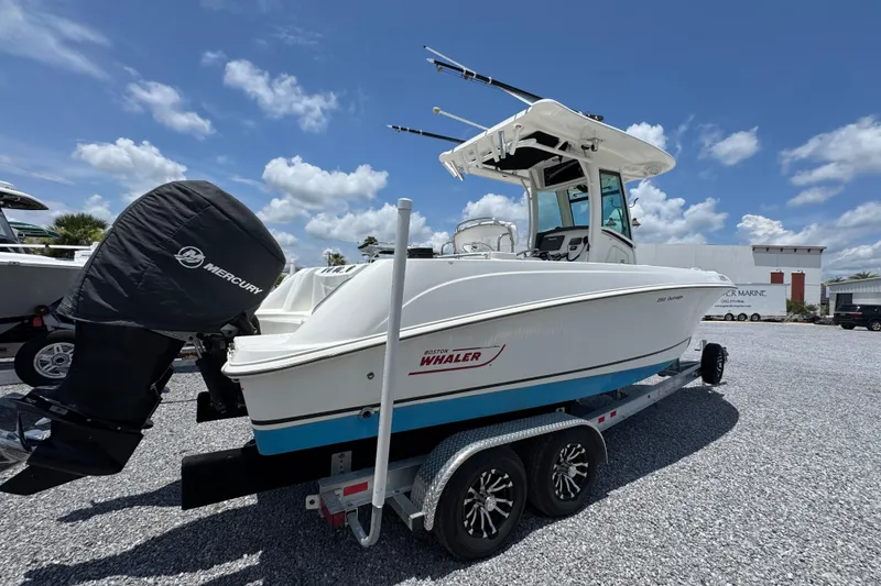 Slide: The Image of 2014 Boston Whaler 250 Outrage boat on trailer under clear blue sky. - 10