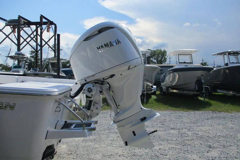 Slide: The Image of 2026 Sportsman Masters 247OE Bay Boat with Yamaha outboard engine in a boatyard. - 3