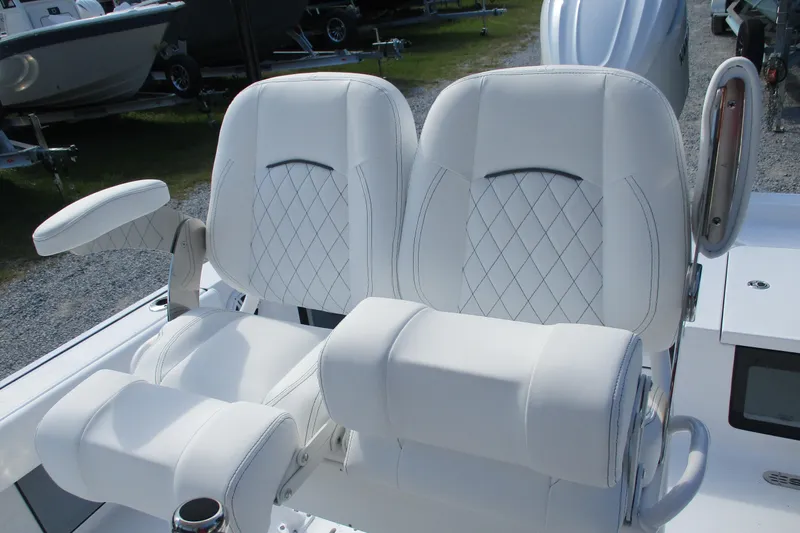 Slide: The Image of Luxurious seating on 2026 Sportsman Masters 247OE Bay Boat, featuring diamond-stitched white upholstery. - 7