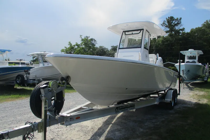 Slide: The Image of 2026 Sportsman Masters 247OE Bay Boat on trailer, parked outdoors. - 2