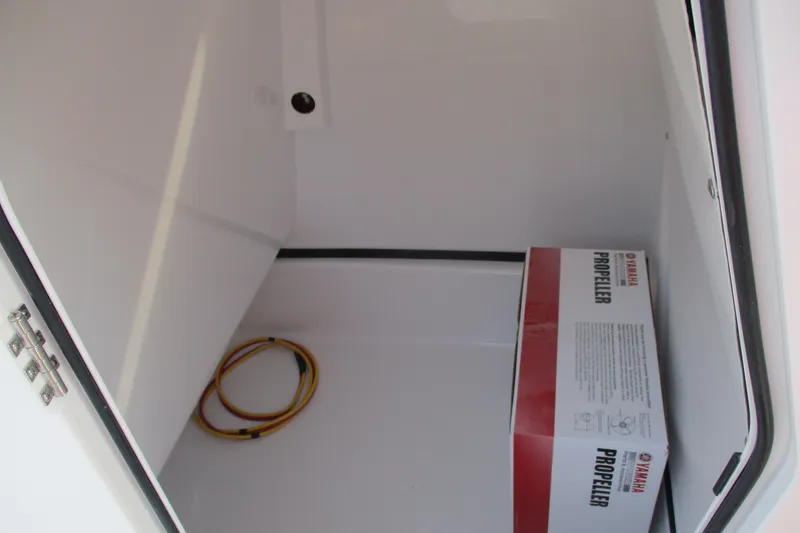 Slide: The Image of Storage compartment of 2026 Sportsman Masters 247OE Bay Boat with Yamaha propeller box. - 18