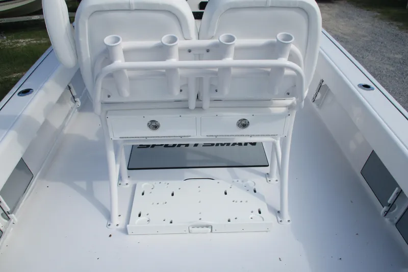 Slide: The Image of 2026 Sportsman Masters 247OE Bay Boat interior with rod holders and storage drawers. - 14