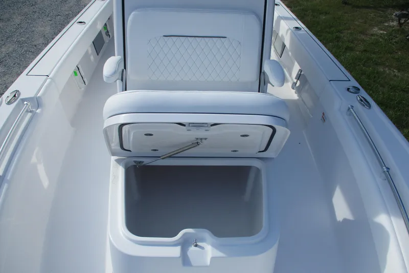 Slide: The Image of 2026 Sportsman Masters 247OE Bay Boat interior with open storage compartment and cushioned seating. - 6