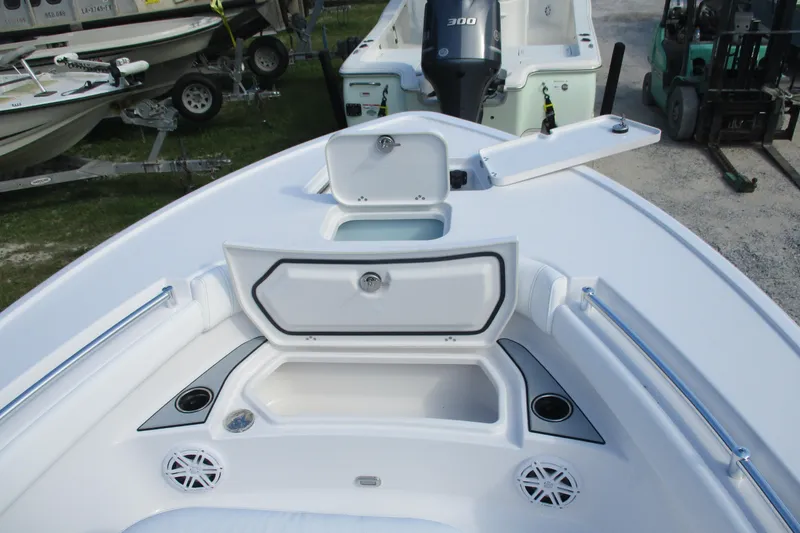 Slide: The Image of 2026 Sportsman Masters 247OE Bay Boat interior with storage compartments and speakers. - 17