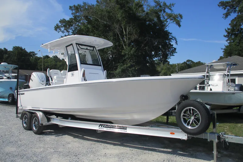 Slide: The Image of 2026 Sportsman Masters 247OE Bay Boat on trailer, parked outdoors. - 1