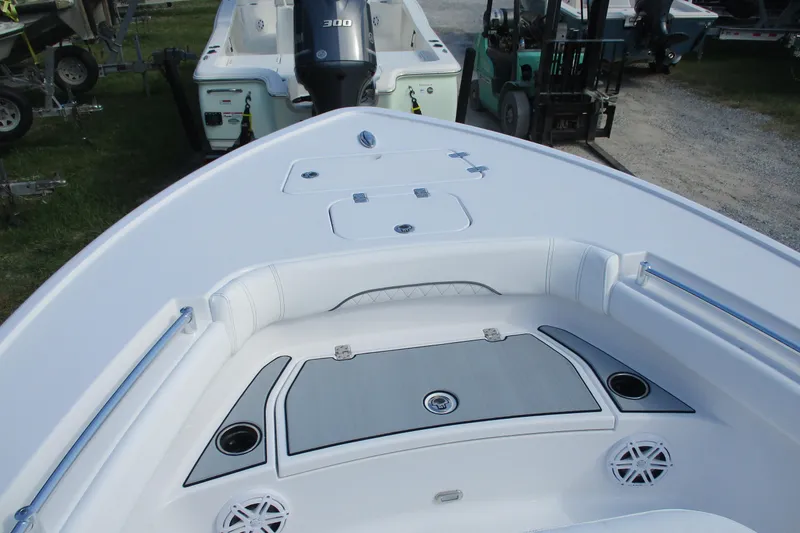 Slide: The Image of 2026 Sportsman Masters 247OE Bay Boat deck with seating and storage compartments. - 16
