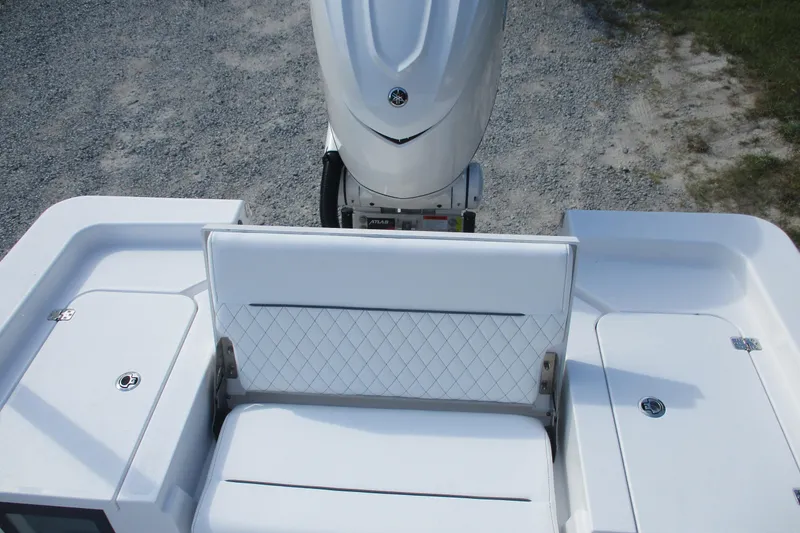 Slide: The Image of 2026 Sportsman Masters 247OE Bay Boat with white seating and engine view. - 9