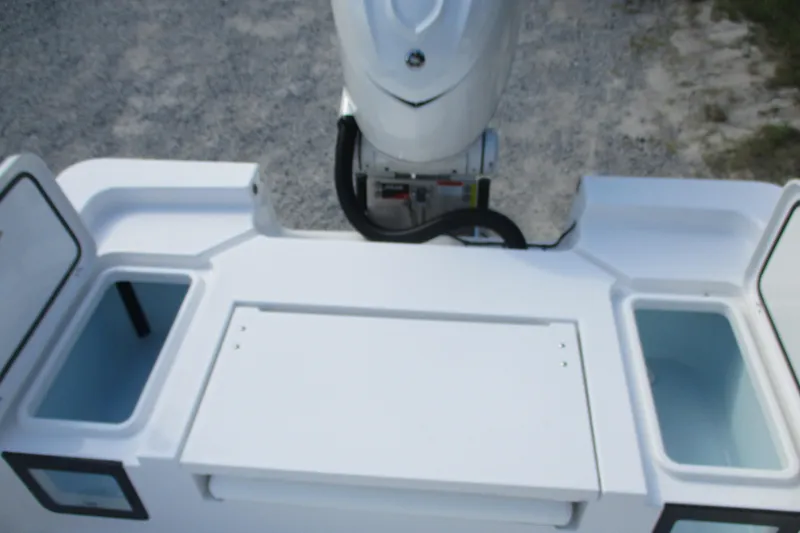 Slide: The Image of 2026 Sportsman Masters 247OE Bay Boat stern view with open storage compartments. - 12