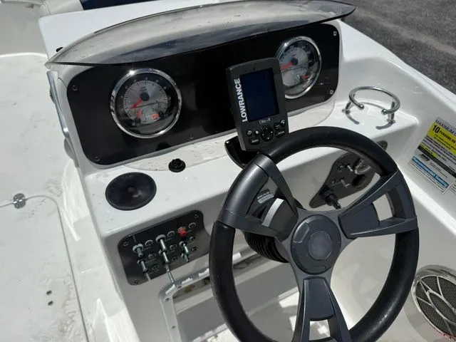 Slide: The Image of Cockpit of a 2014 Hurricane 201 Sun Deck Sport with steering wheel and instruments. - 8