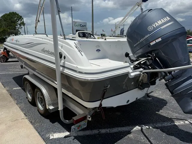 Slide: The Image of A 2014 Hurricane 201 Sun Deck Sport boat on a trailer with a Yamaha outboard motor. - 6