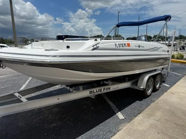 Slide: The Image of A white 2014 Hurricane 201 Sun Deck Sport boat on a trailer with a blue canopy. - 7