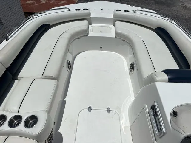 Slide: The Image of The image shows the spacious cockpit of a 2014 Hurricane 201 Sun Deck Sport boat with white upholstery. - 9