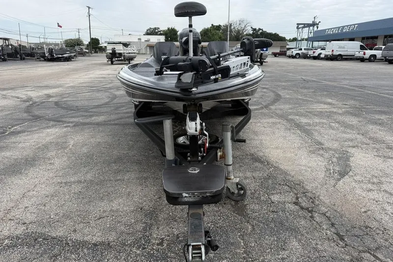 Slide: The Image of 2014 Skeeter FX210 boat on trailer in parking lot, tackle department in background. - 7