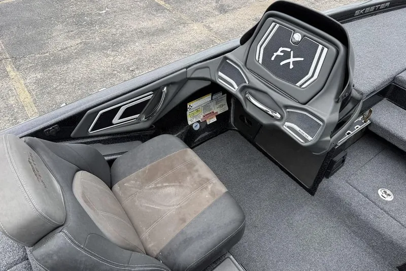 Slide: The Image of 2014 Skeeter FX210 boat interior with driver's seat and control panel. - 17