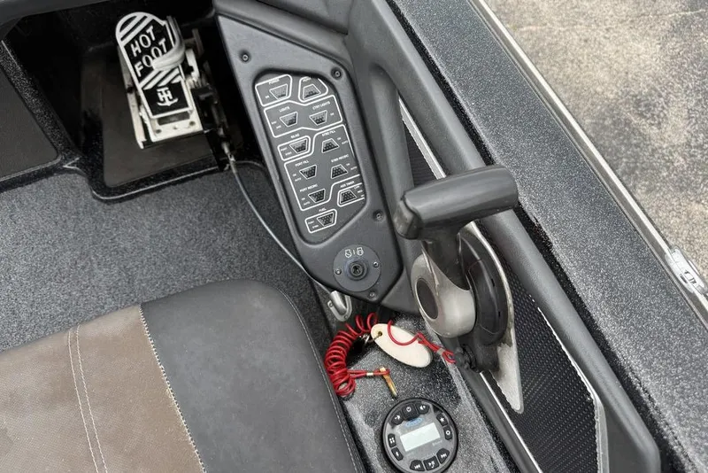 Slide: The Image of 2014 Skeeter FX210 boat cockpit with control panel, throttle, and "Hot Foot" pedal. - 10