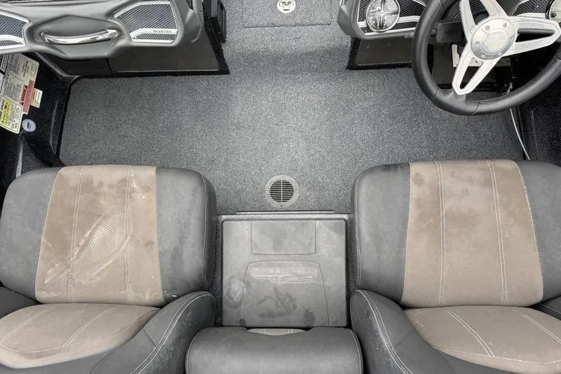 Slide: The Image of 2014 Skeeter FX210 boat interior with dual seats and steering wheel. - 13