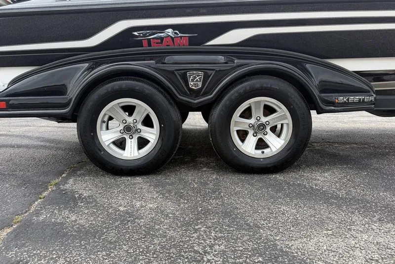 Slide: The Image of 2014 Skeeter FX210 trailer with dual wheels on asphalt surface. - 5
