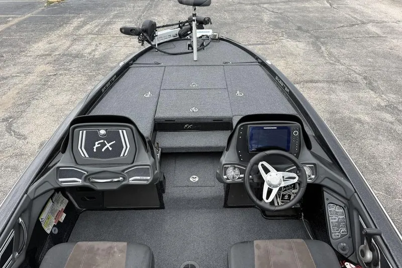 Slide: The Image of 2014 Skeeter FX210 boat interior with steering wheel and control panel. - 9