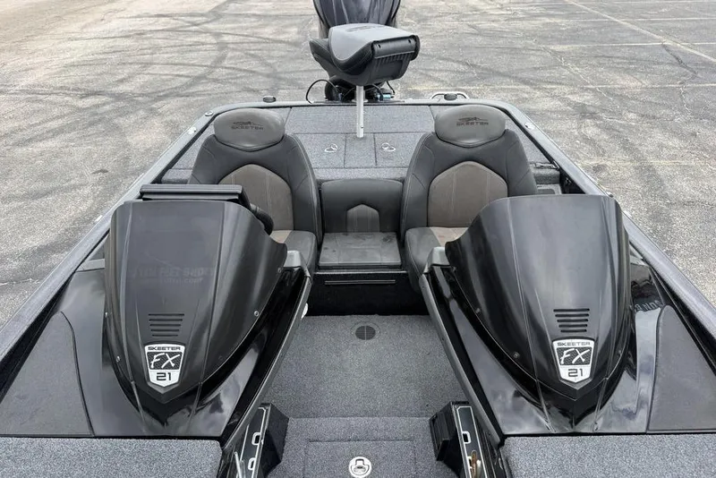Slide: The Image of 2014 Skeeter FX210 boat interior with dual seats and sleek black design. - 12