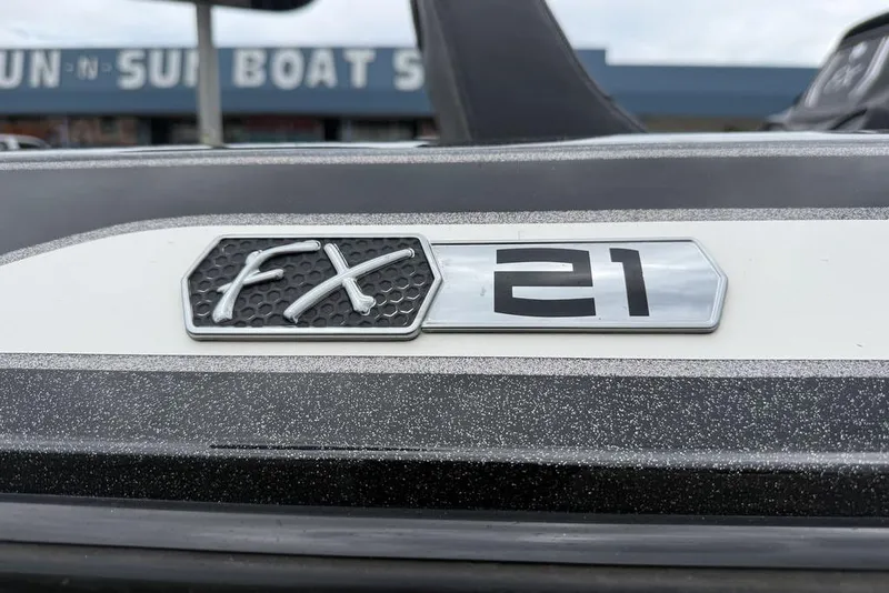 Slide: The Image of 2014 Skeeter FX210 boat emblem close-up with dealership in background. - 3