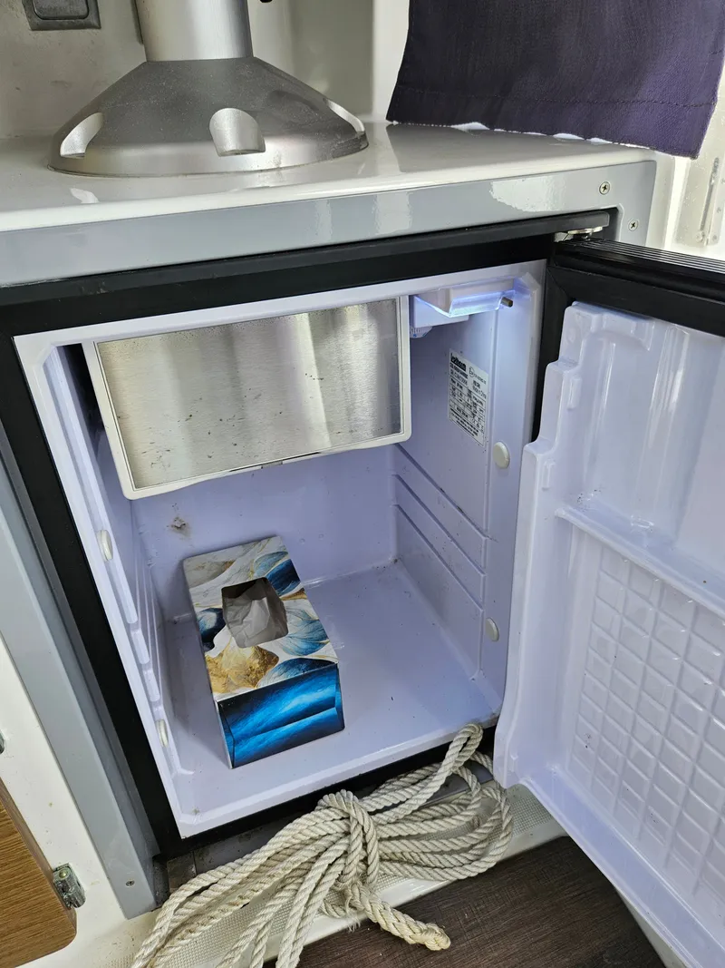 Slide: The Image of Open fridge with tissue box and rope inside. - 11