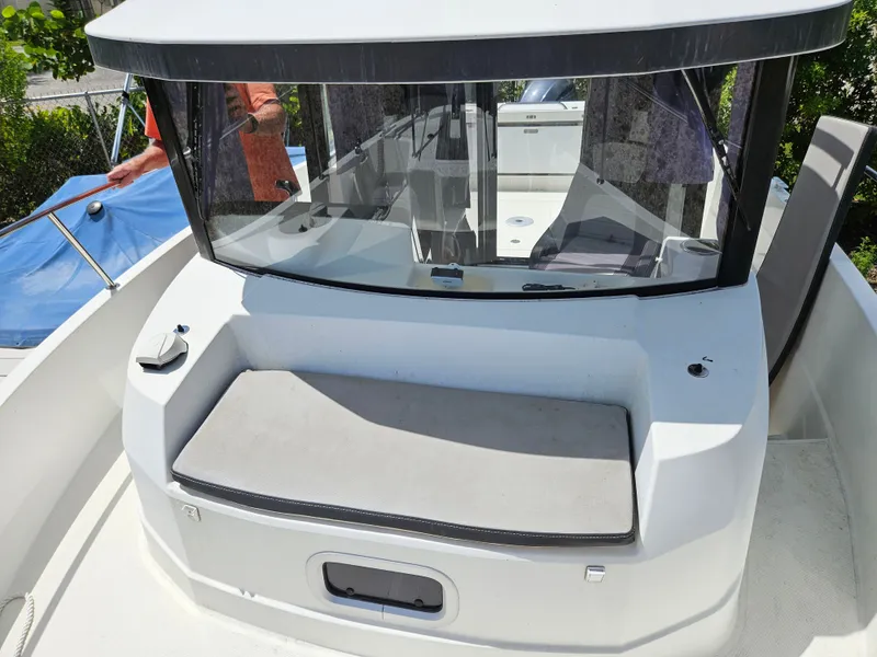 Slide: The Image of The image shows the foredeck of a 2020 Jeanneau NC 795 with a seating area. - 2