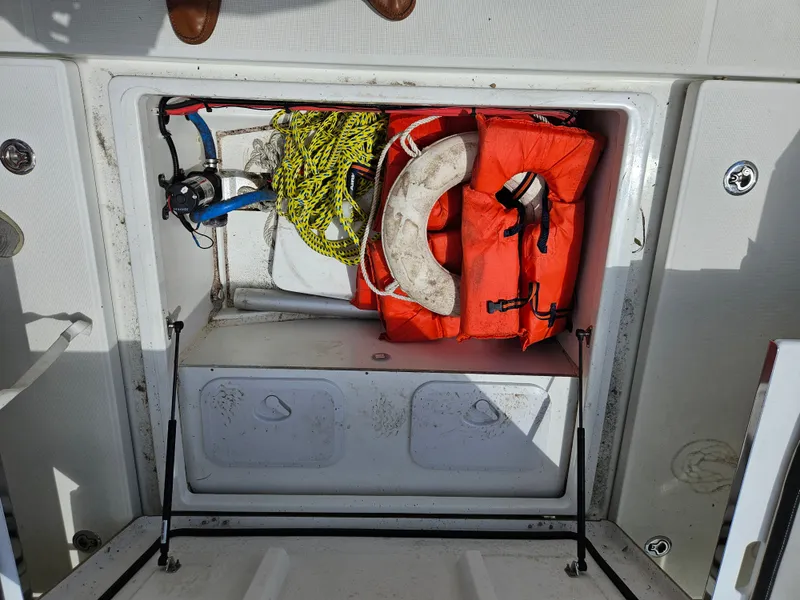 Slide: The Image of An open storage compartment with life jackets, a lifebuoy, and ropes. - 15