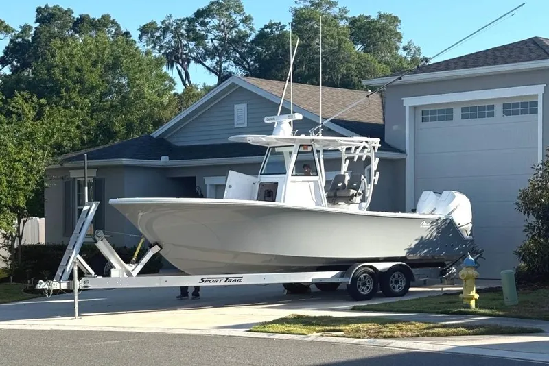 Slide: The Image of 2023 Onslow Bay 27 Offshore Edition boat on trailer in residential driveway. - 1