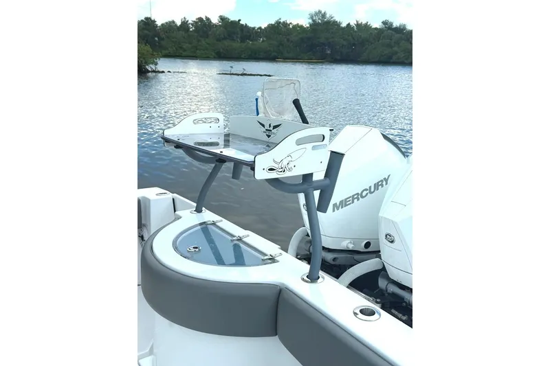 Slide: The Image of 2023 Onslow Bay 27 Offshore Edition boat with Mercury engine on a serene lake. - 7
