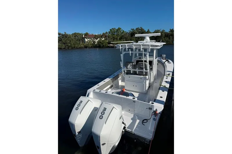 Slide: The Image of 2023 Onslow Bay 27 Offshore Edition boat with dual engines on a calm waterway. - 5