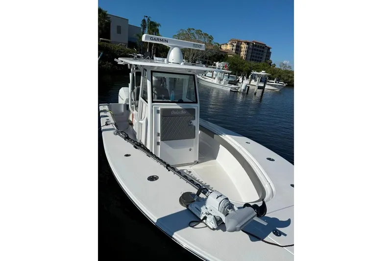 Slide: The Image of 2023 Onslow Bay 27 Offshore Edition boat docked on calm water. - 6