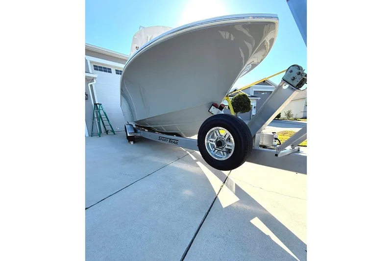 Slide: The Image of 2023 Onslow Bay 27 Offshore Edition boat on trailer in driveway. - 3