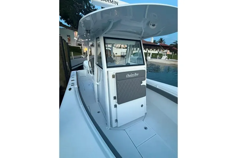 Slide: The Image of 2023 Onslow Bay 27 Offshore Edition boat docked by the water. - 8