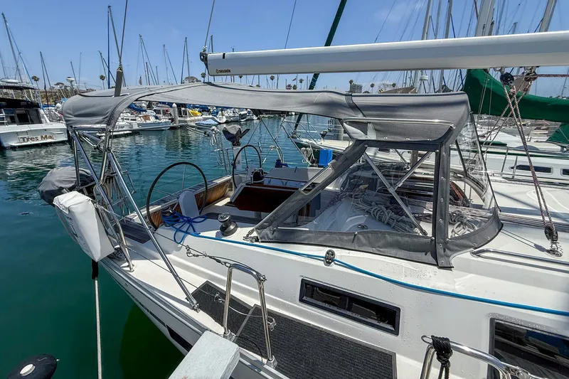 Slide: The Image of Sailboat Bavaria Cruiser 37, 2014 model, docked in a marina with protective canopy. - 30