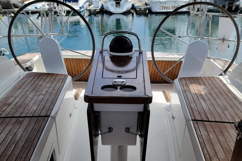 Slide: The Image of The cockpit of a 2014 Bavaria Cruiser 37 with dual steering wheels and wooden flooring. - 22