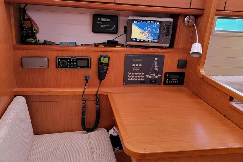 Slide: The Image of The navigation area of a 2014 Bavaria Cruiser 37 with electronic equipment and a radio. - 7