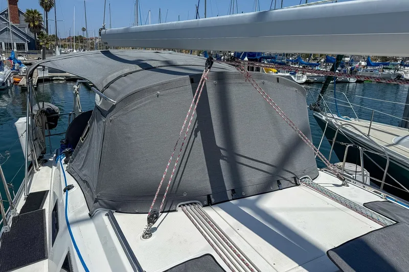 Slide: The Image of 2014 Bavaria Cruiser 37 sailboat docked at a marina with a covered cockpit. - 61