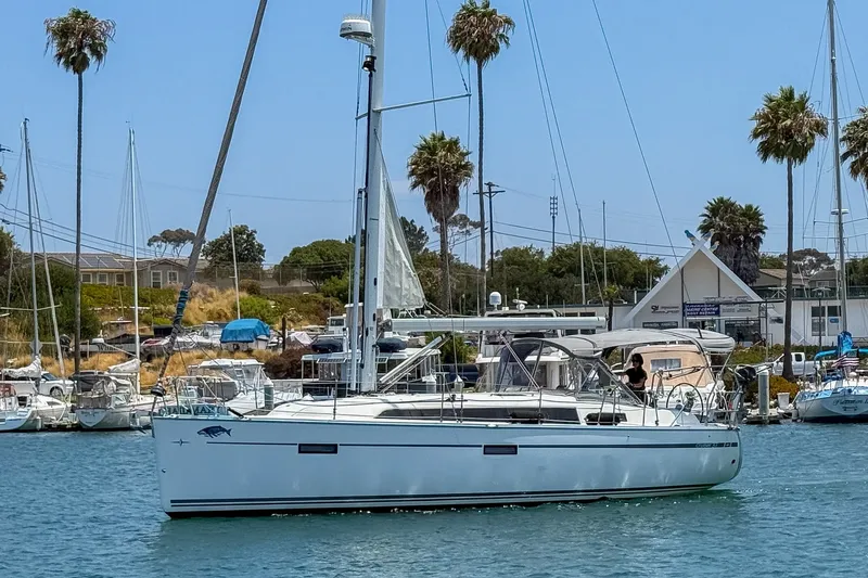 Slide: The Image of 2014 Bavaria Cruiser 37 sailboat docked in a marina with palm trees. - 3