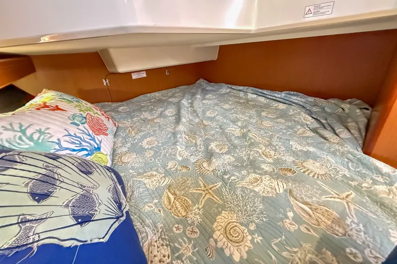 Slide: The Image of Cozy cabin bed in 2014 Bavaria Cruiser 37 with nautical-themed bedding. - 19