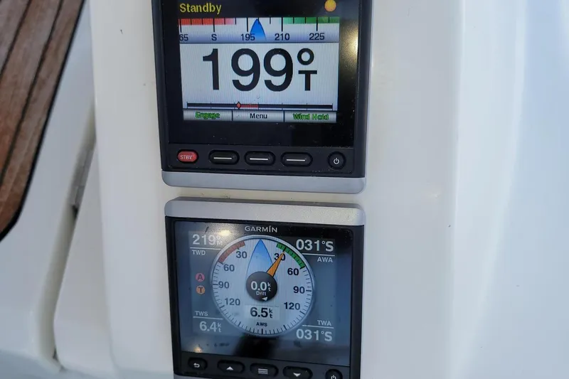 Slide: The Image of Two navigation screens on a 2014 Bavaria Cruiser 37 display course and speed information. - 32