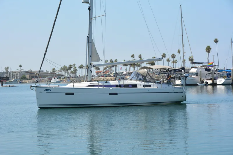Slide: The Image of A 2014 Bavaria Cruiser 37 is docked in a harbor, surrounded by other boats. - 3
