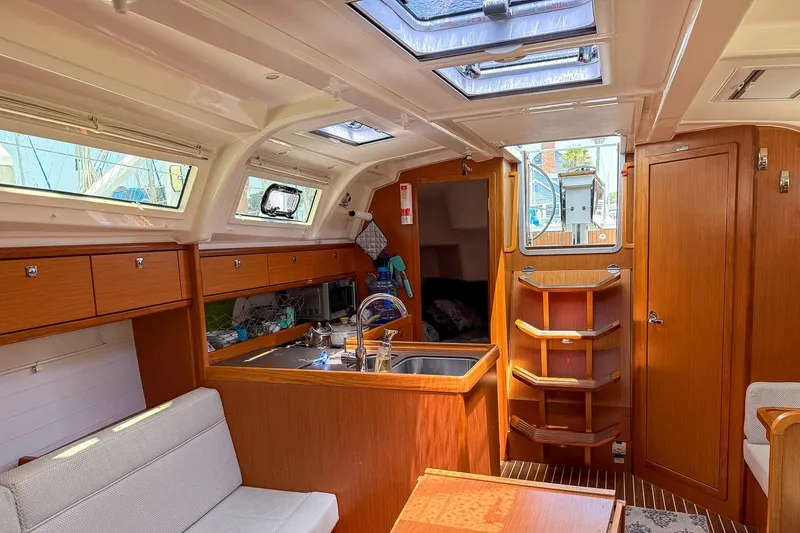 Slide: The Image of Interior of 2014 Bavaria Cruiser 37 yacht with wooden cabinetry and seating area. - 13