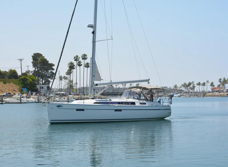Slide: The Image of A white sailing yacht calmly on the water, surrounded by palm trees and a clear sky. - 46