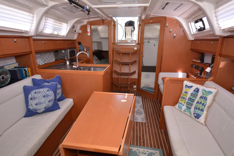 Slide: The Image of Interior of a 2014 Bavaria Cruiser 37 with wooden furnishings and cozy seating areas. - 6