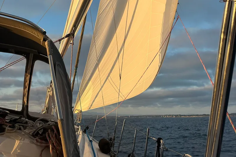 Slide: The Image of Sailing on a 2014 Bavaria Cruiser 37 with sunlit sails over the ocean. - 65