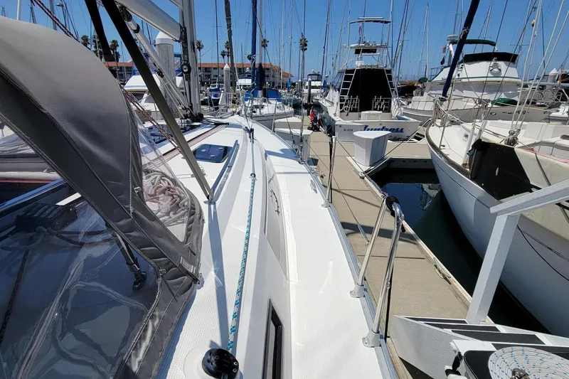 Slide: The Image of A 2014 Bavaria Cruiser 37 docked in a marina, surrounded by other boats. - 27